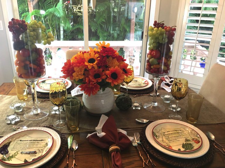 Elegant table setting with flowers and fruits.