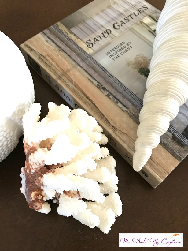 coffee table book and sea shells in coastal living decor