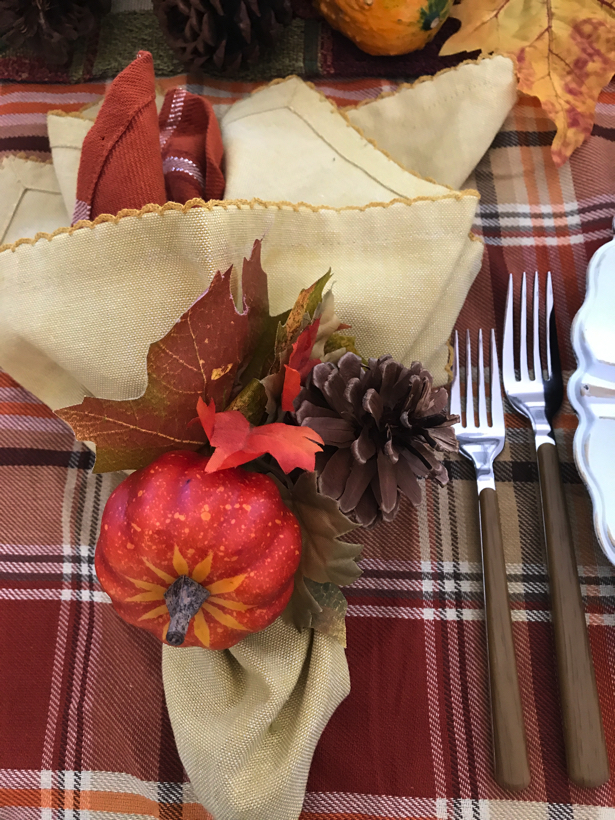 Autumn dining with double napkins fastened with pumpkin napkin ring.