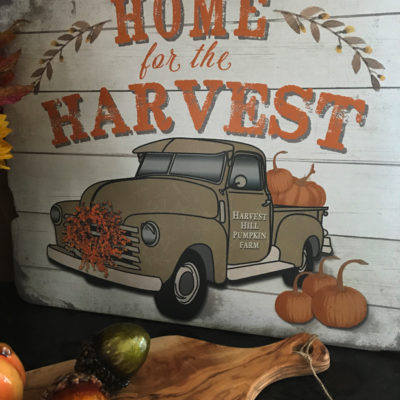Home for the Harvest sign with a truck and pumpkins