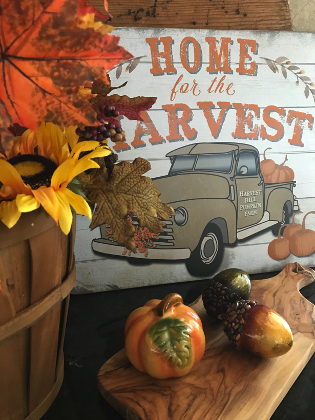 home for the harvest vignette with pumpkins and fall leaves.