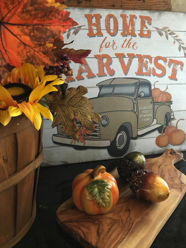 home for the harvest pick-up truck with pumpkins in the bed.
